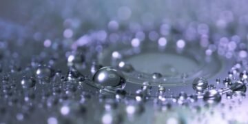 Captivating macro photograph of water droplets highlighting reflection and clarity.